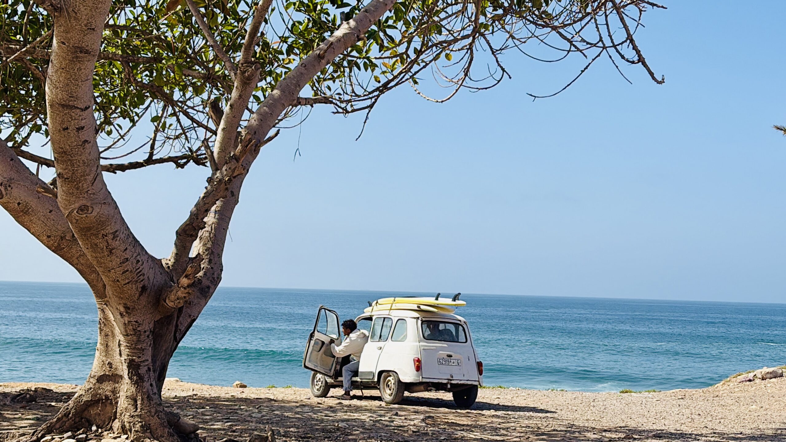 Old Renault with surfboards in Morocco